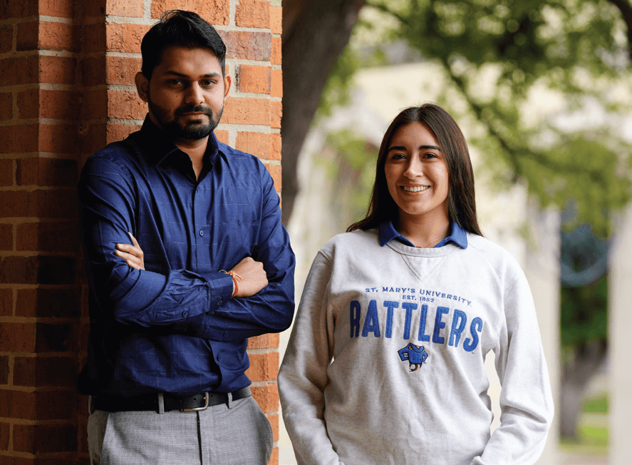 Two St. Mary's University students smile as they walk around the campus.