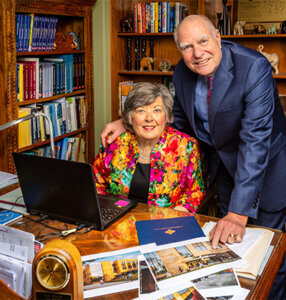 Sallie Sheppard and Leland Blank stand at a desk with a rendering of the new innovation center.