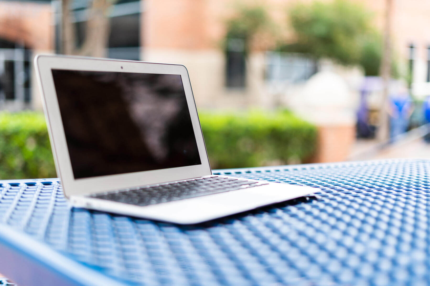 An open laptop on a blue table